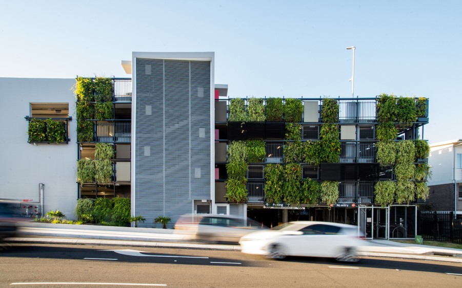 The B-Line Manly Vale carpark facade features a mosaic of vertical gardens that are green and lush